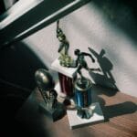 Statuetki baseballowe i piłkarskie na półce w świetle słońca